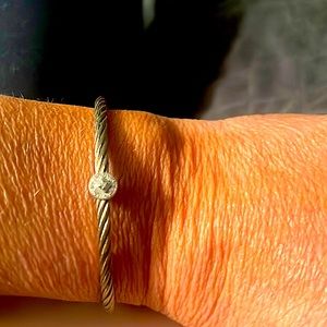 CHARIOLL gold cable bracelet with circle pendent surrounded with diamonds.